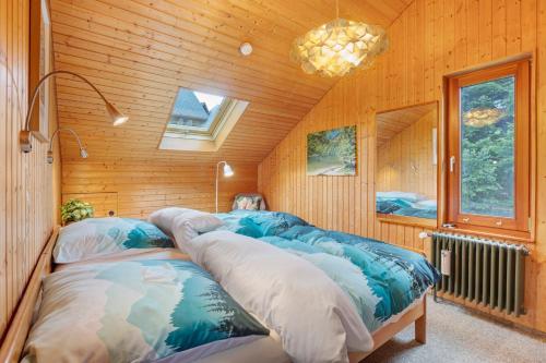 a room with two beds in a wooden cabin at Ferienwohnung Black Forest Hideaway in Todtnau