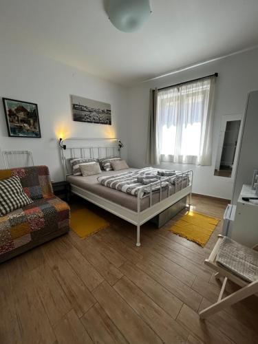 a bedroom with a bed and a couch at B&B Isola in Izola