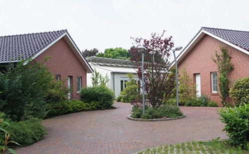 a brick driveway in front of two brick houses at Ferienzentrum Brouwer, 75010 in Westoverledingen