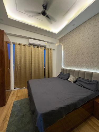 a bedroom with a large bed in a room at THE COZY STAY STUDio in Greater Noida