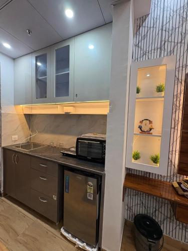 a kitchen with a sink and a counter top at THE COZY STAY STUDio in Greater Noida