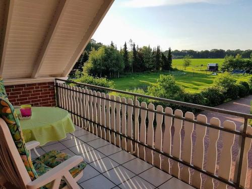 a balcony with a table and a view of a field at Ferienwohnung Hahn, 95129 in Rhauderfehn