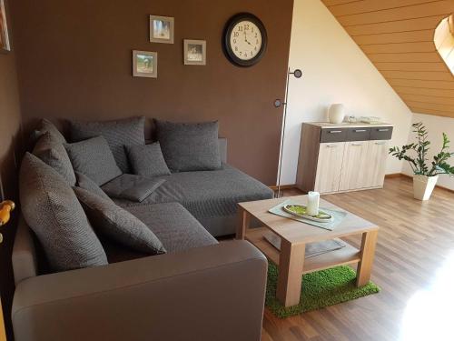 a living room with a couch and a table at Ferienwohnung Hahn, 95129 in Rhauderfehn