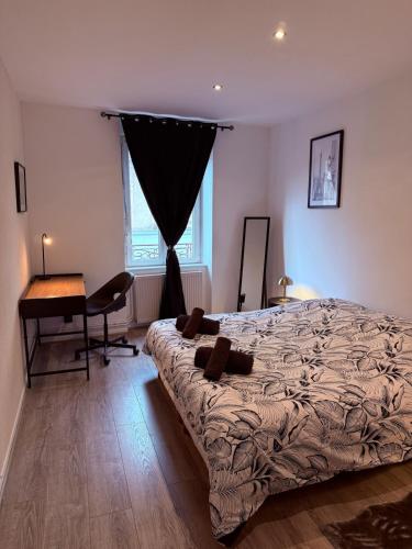 a bedroom with a bed and a desk and a window at T3 spacieux - Centre et Technhom in Belfort