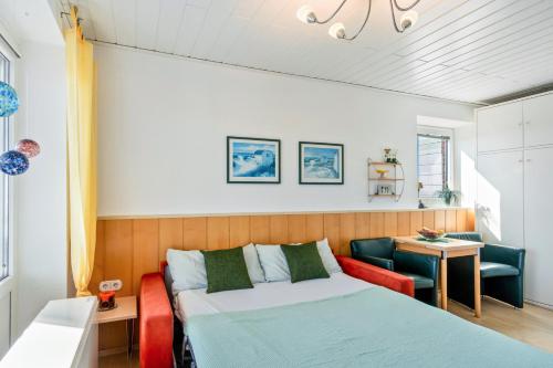 a bedroom with a bed and a table and a chair at Apartment Korthals 41 in Wangerland