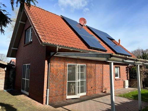a house with solar panels on top of it at Ferien_HAUS SEEOASE in Göhren-Lebbin