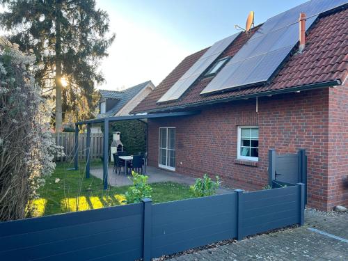 a house with a roof with solar panels on it at Ferien_HAUS SEEOASE in Göhren-Lebbin