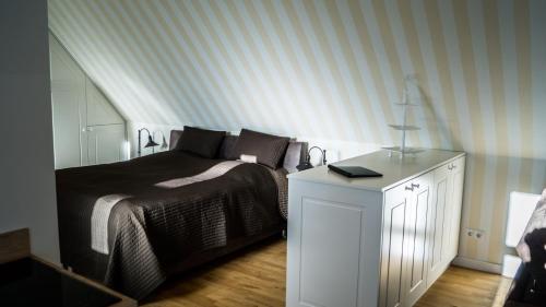 a bedroom with a bed and a white dresser at Hotel Haus Broichtal in Alsdorf