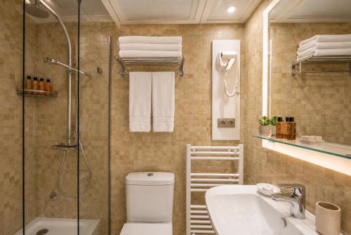 a bathroom with a shower and a toilet and a sink at Appart-hotel Marrakech Inn in Marrakesh