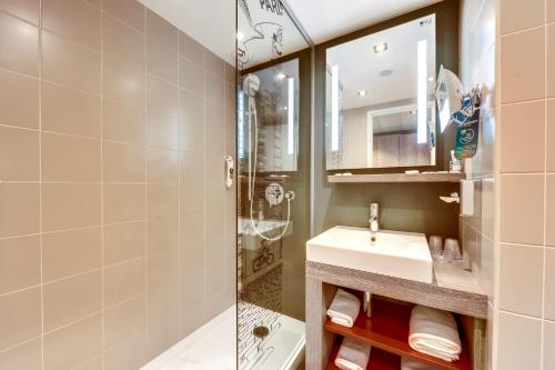 a bathroom with a sink and a shower at Hôtel Mercure Paris Centre Gare Montparnasse in Paris