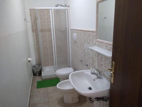 a bathroom with a toilet and a sink and a shower at B&B Josefine in Marina di Camerota