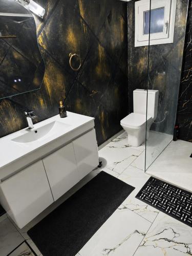 a bathroom with a sink and a toilet at Giorgos Suite - Jacuzzi Hideaway in Lydia, Kavala in Lidia