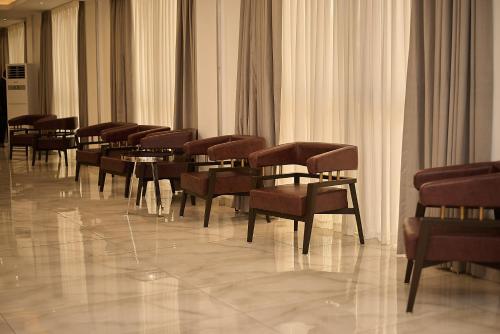 a row of chairs and tables in a room at Accra City Hotel in Accra