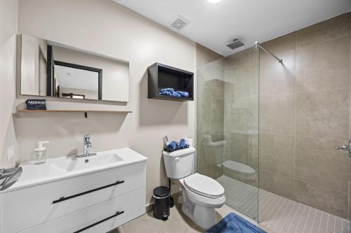 a bathroom with a toilet sink and a shower at Ocean Breeze in San Juan