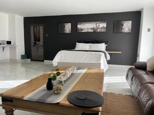 a living room with a bed and a coffee table at Team Sek Guest Studio in Mahikeng