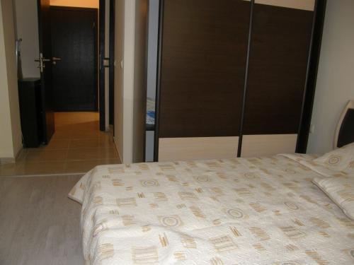 a bedroom with a bed and a door to a hallway at Apartment Horisont 1 in Sozopol