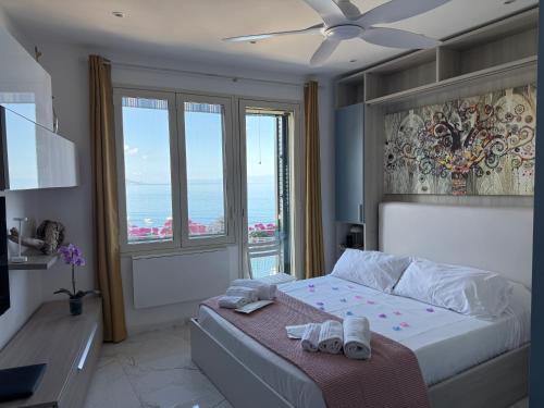 a bedroom with a bed with a view of the ocean at Paradise By The Sea in Taormina