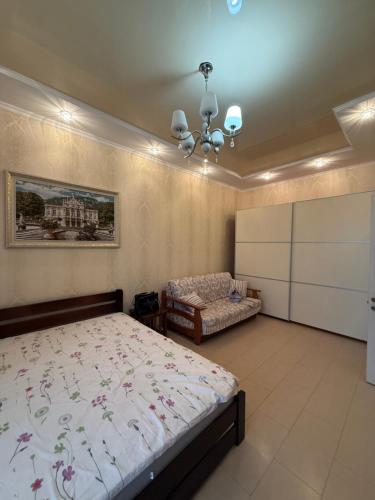 a bedroom with a bed and a couch in it at Квартира Марсельська in Kryzhanivka