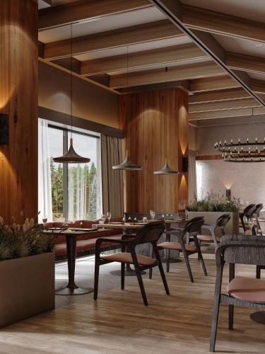 a dining room with a table and chairs at Lake Charvak Resort in Burchmulla