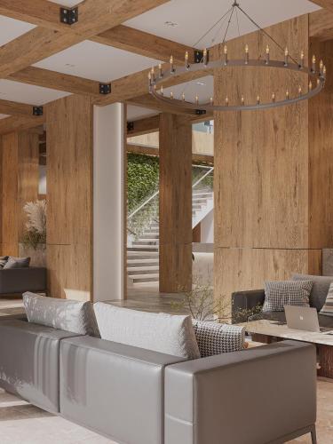 a living room with a couch and a chandelier at Lake Charvak Resort in Burchmulla