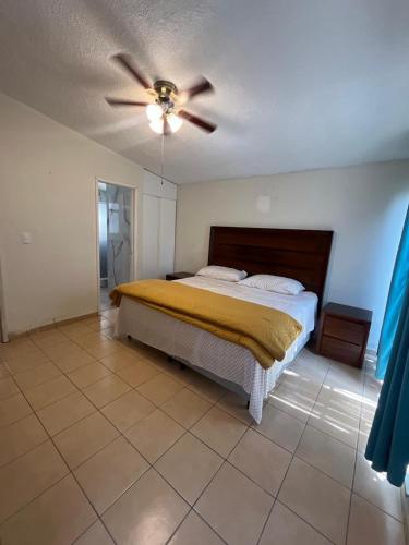a bedroom with a bed and a ceiling fan at Casa en Cuernavaca Morelos in Cuernavaca