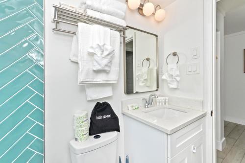 a white bathroom with a sink and a mirror at Fin's Inn & Suites in Myrtle Beach