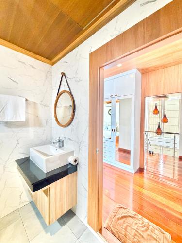 a bathroom with a sink and a mirror at Anara Pool Villa 3 Bedrooms in Nathon Bay