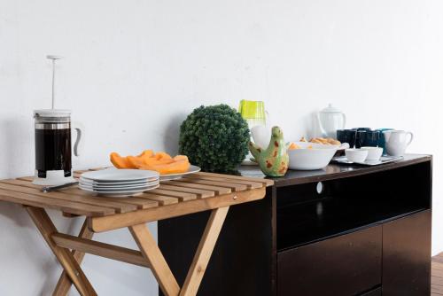 a table with plates of food on top of a counter at Hostal Nube Mia Guadalajara in Guadalajara