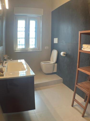 a bathroom with a toilet and a sink at Harmony Suite in Aprilia