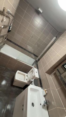 a bathroom with a toilet and a sink at Frobisher Apartment in Erith