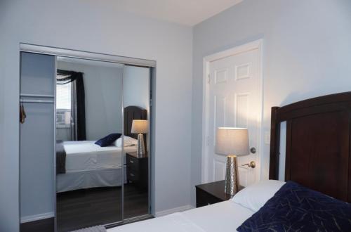 a bedroom with a mirror and a bed and two beds at West New York room 15 in West New York