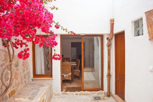a house with pink flowers on the side of it at Ca nostra in Artá
