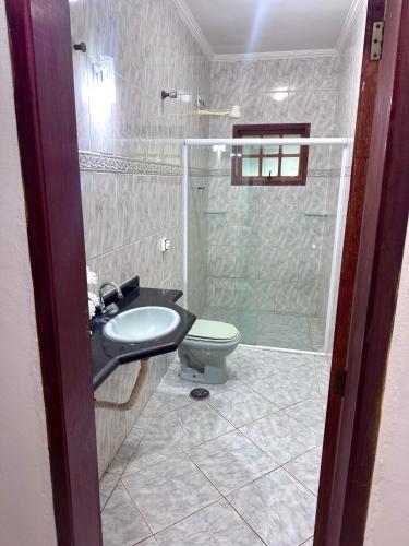 a bathroom with a toilet and a sink and a shower at quarto suíte privativo em campinas para até 3 pessoas in Campinas