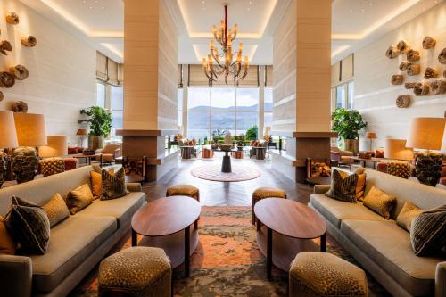 a lobby with couches and tables and a chandelier at The Europe Hotel & Resort in Killarney