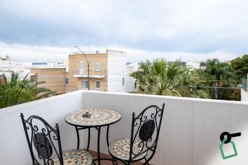 a balcony with a table and chairs on a balcony at Hotiday Porto Cesareo in Porto Cesareo