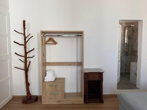 a dressing room with a mirror and a wooden dresser at Douskos Guesthouse in Hydra