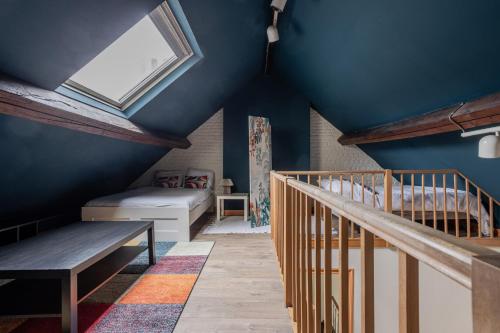 a room with blue walls and a skylight at Brussels Guest House in Brussels