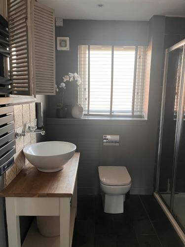 a bathroom with a white sink and a toilet at Cool Getaway in Appin in Portnacroish