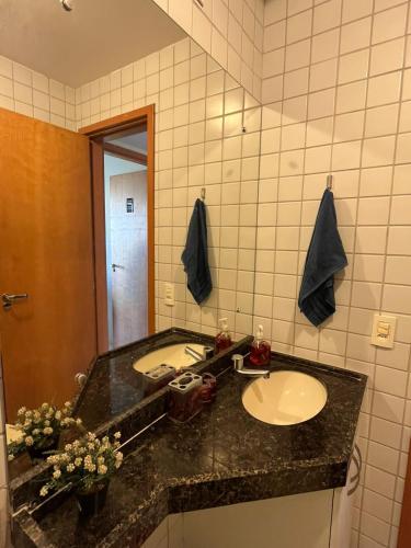 a bathroom with a sink and a mirror at Flat Monte Castelo em Gravata PE in Gravatá