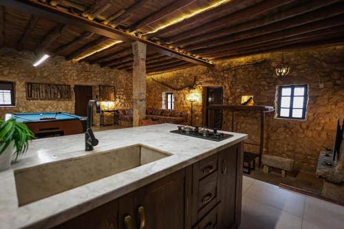a large kitchen with a sink and a pool table at Beit el loz in Ghazīr