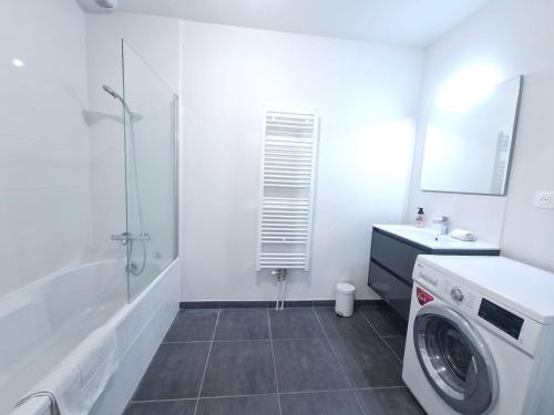a white bathroom with a washing machine in it at Le Savannah #Parking#Terrasse in Clermont-Ferrand