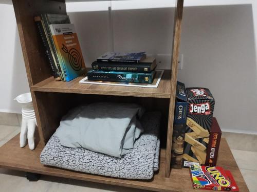 a book shelf filled with books and other items at Casita del Valle in San Cristóbal