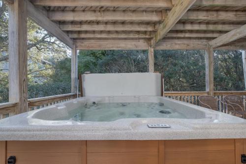 a jacuzzi tub on a screened in porch at 2507 - Salty Sandpiper in Duck