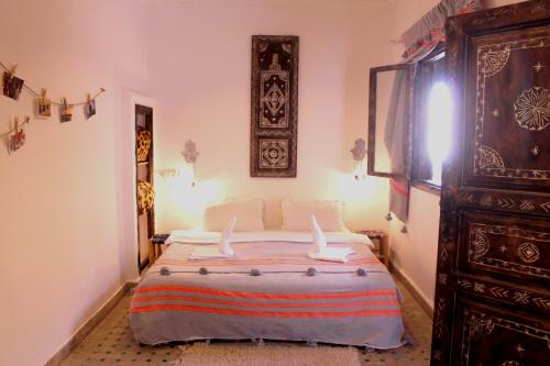 a bedroom with a large bed in a room at Riad Inna & Watersports Center in Essaouira