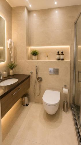 a bathroom with a toilet and a sink and a shower at Zlatý Sloup in Karlovy Vary