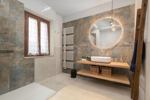 a bathroom with a sink and a mirror at Villa Sabrina by PosarelliVillas in San Gimignano