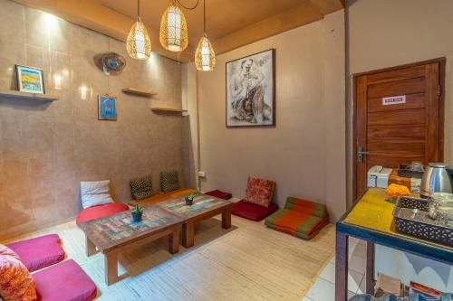a living room with a table and some chairs at Aru House Ubud in Ubud