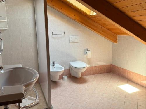 a bathroom with a toilet and a sink at Smart Rooms Miramare in Sottomarina