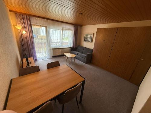 a living room with a table and a couch at Gonenstein 11 in Leukerbad