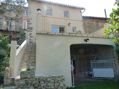 an external view of a house with a balcony at Oustalou in Saint-Rome-de-Tarn